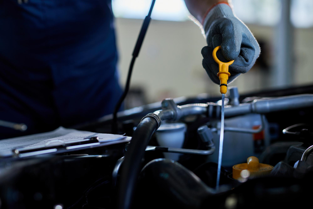 Mechanic changing engine oil at NM Performance Automotive workshop in Sydney’s Northern Beaches