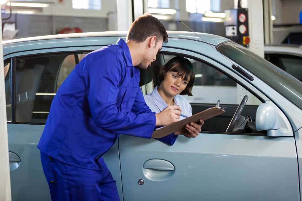Mechanic inspecting a used car before purchase